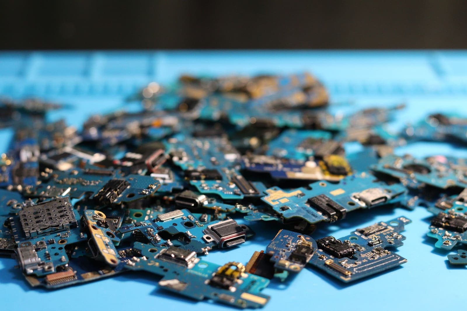 A heap of circuit boards removed from discarded electronics