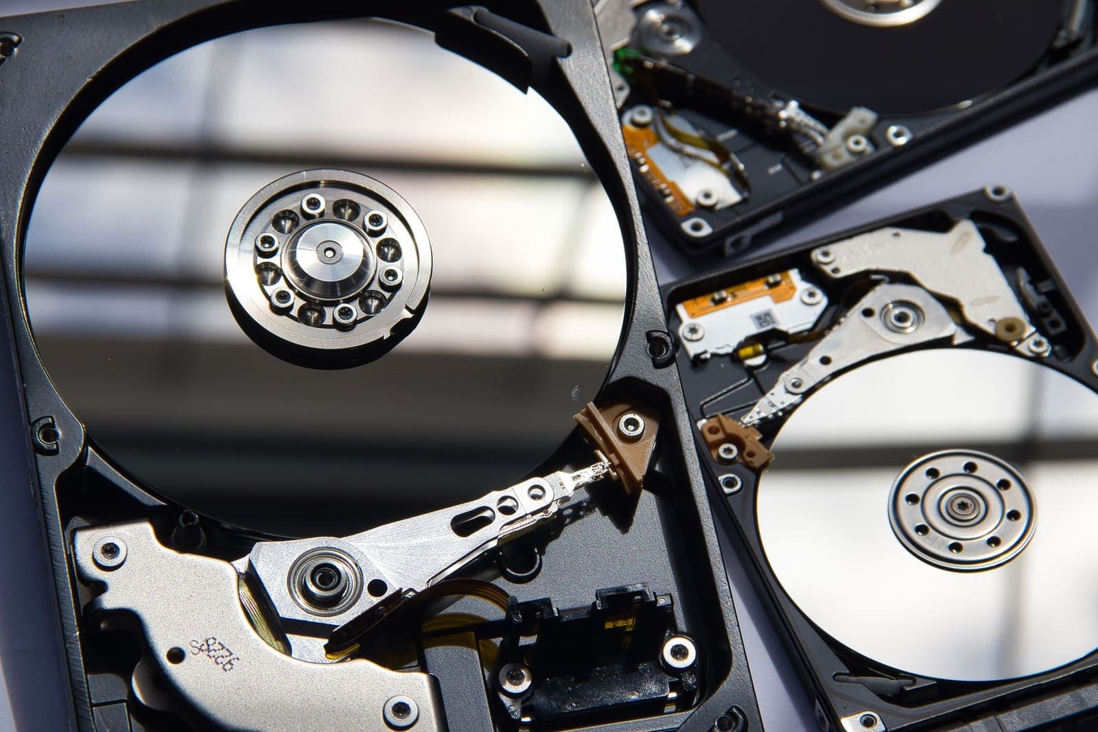 Opened hard drives with their platters and read arms exposed