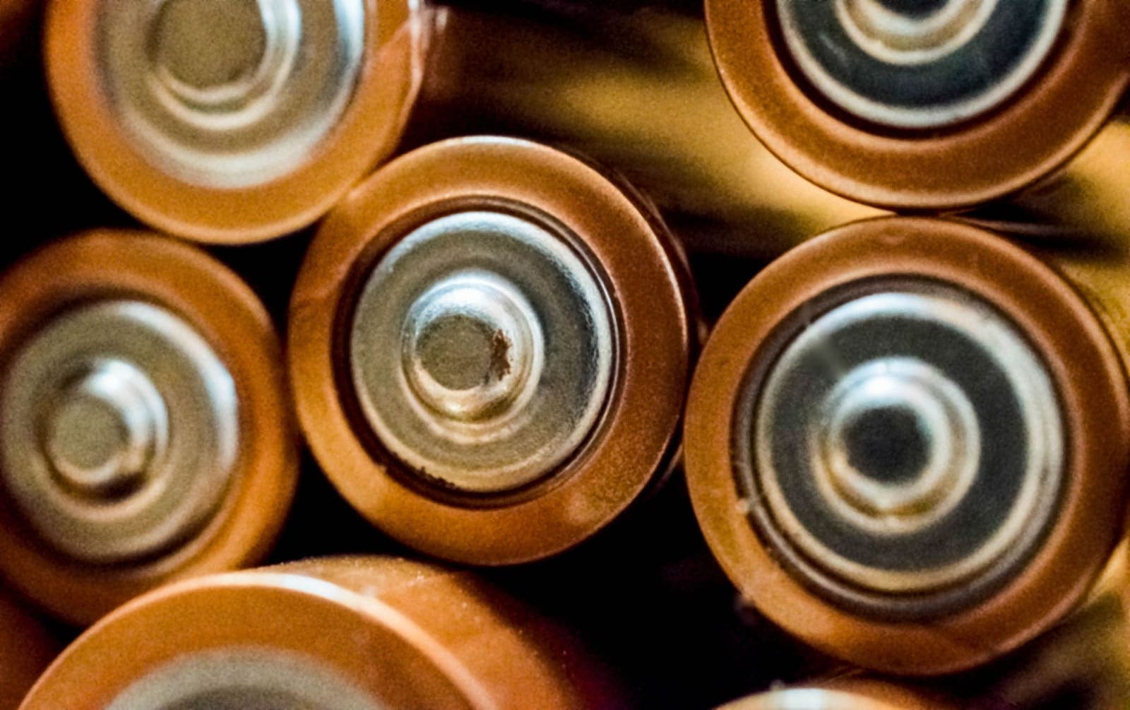 Close-up of the terminals of several cylindrical battery cells